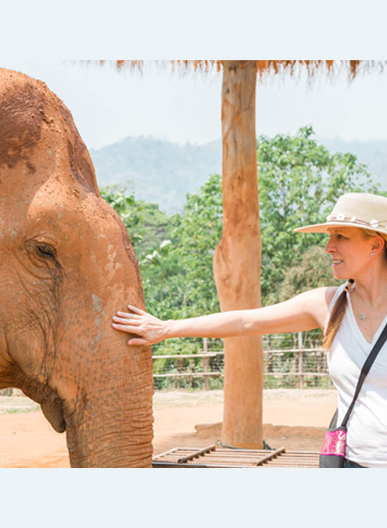 Kathleen with baby elephant in Thailand.